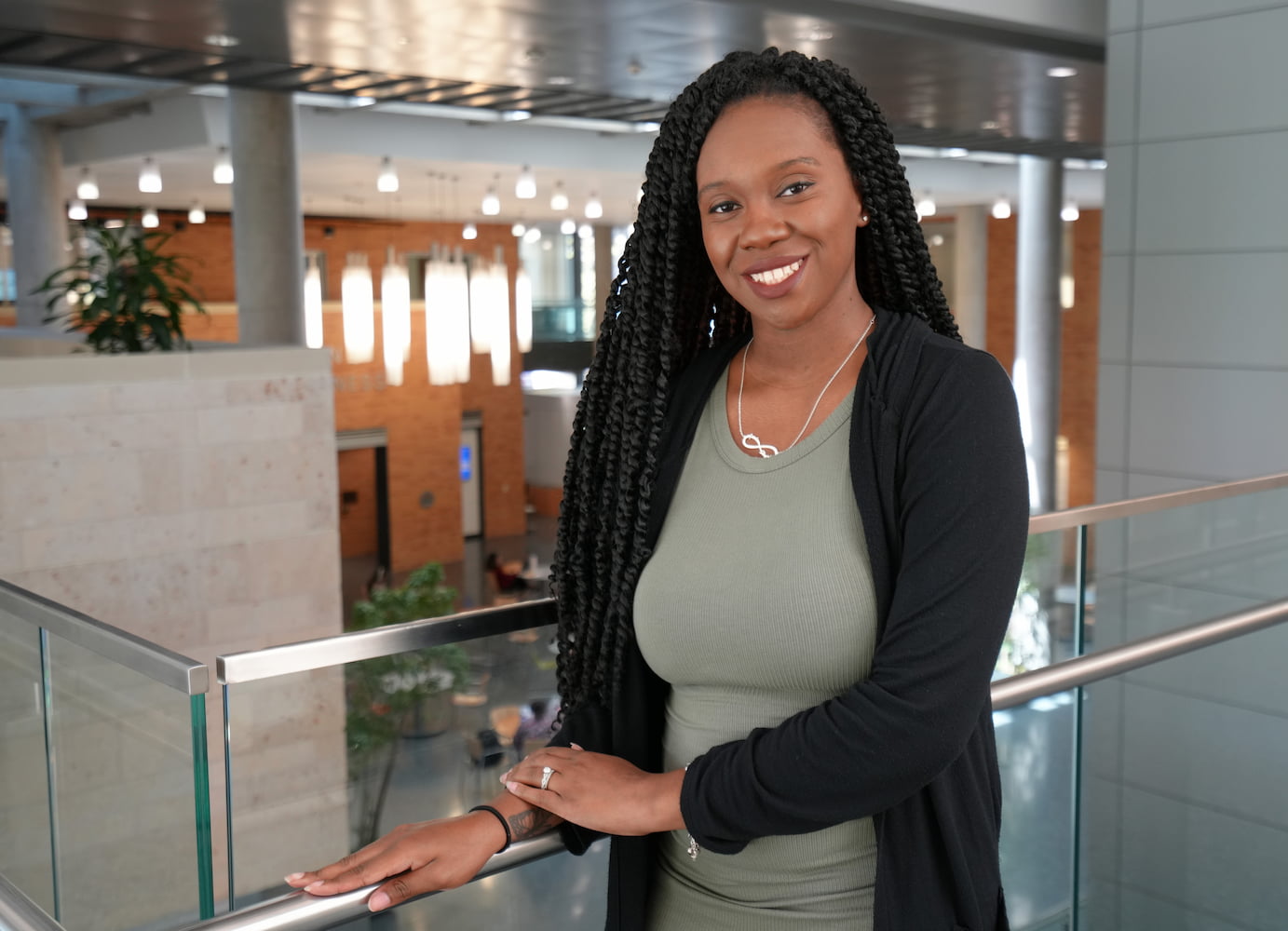 Alexis Coady poses in formal attire in the Bussienss Leadership Building's Atrium